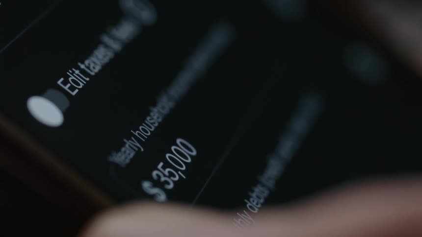 An extreme close up of a person typing numbers on a tablet screen then scrolling down the page