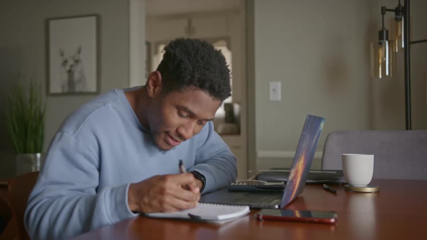 The view is of a portrait of a man that is on his laptop