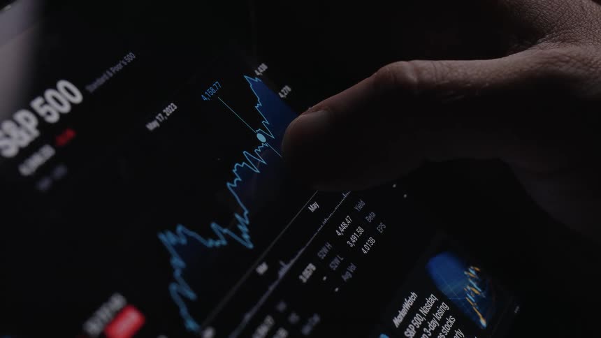 A person touches the graph on the application
