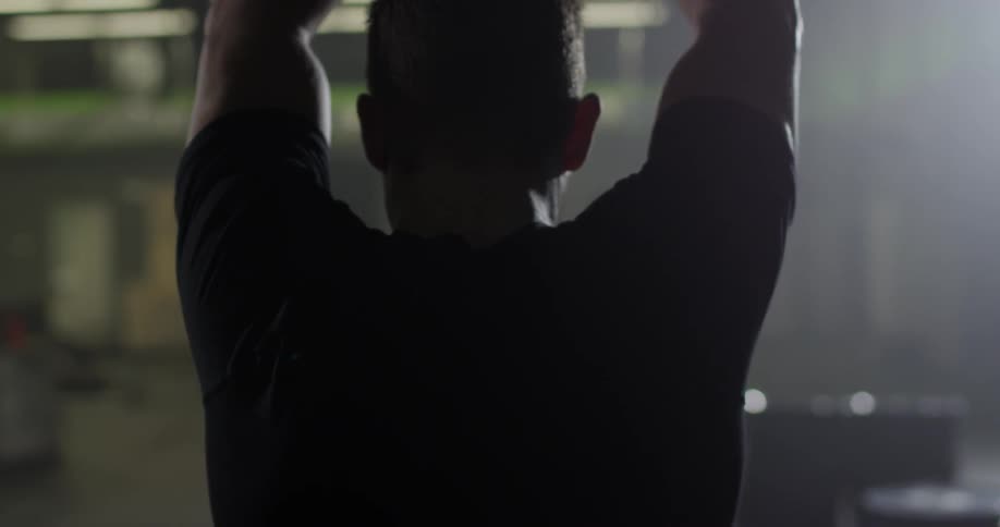 A man walks forward stretching