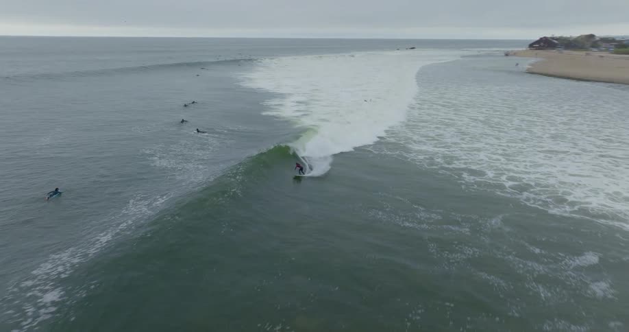 People are surfing by the shore