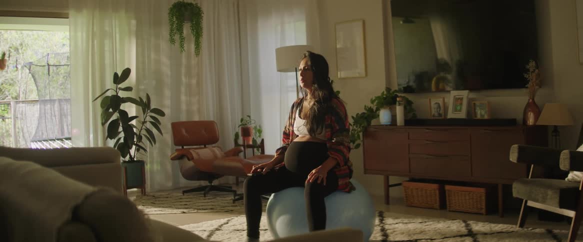 The view is of a portrait of a woman that is inside of her home