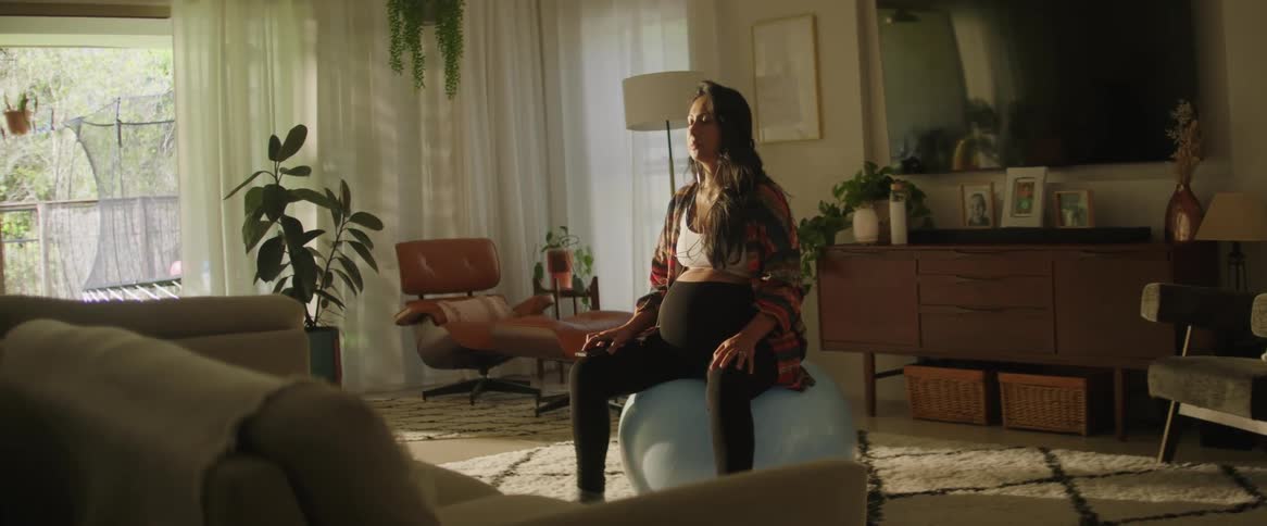 A woman seated on a balloon mediating in the room