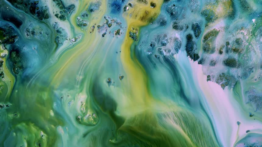 A liquid mixture of paint moving downward like water on a shore