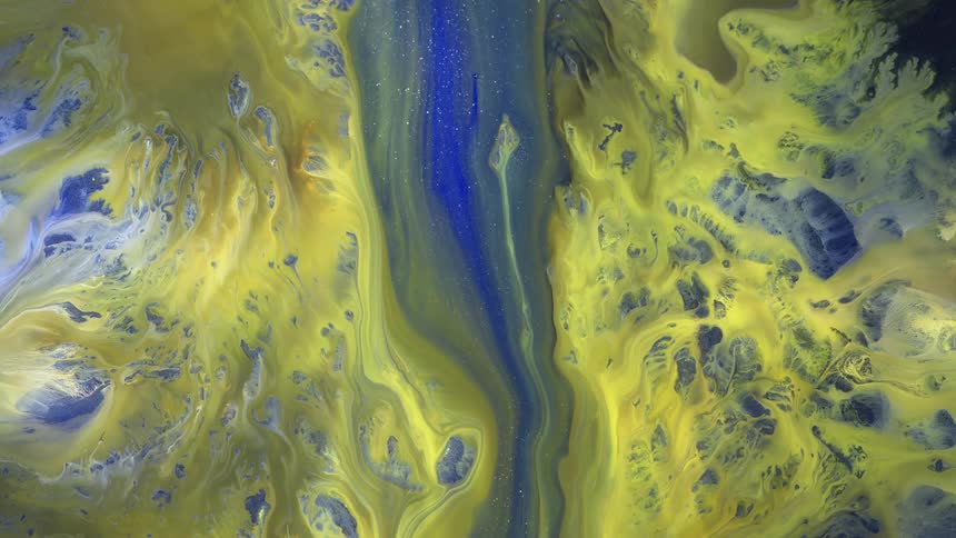 A blue sparkling river flows across the yellow mountains