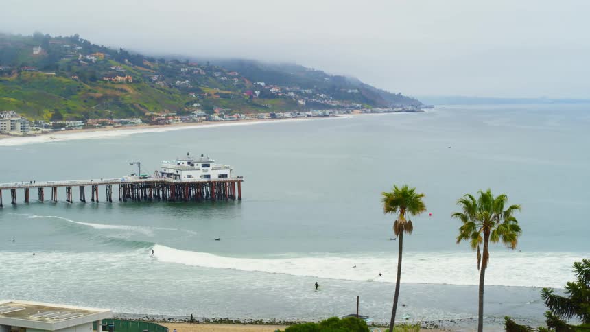Aerial view of a Malibu with surfers riding good waves