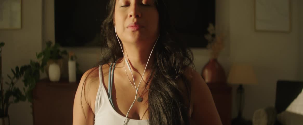Pregnant woman relaxing listening to music on a smartphone