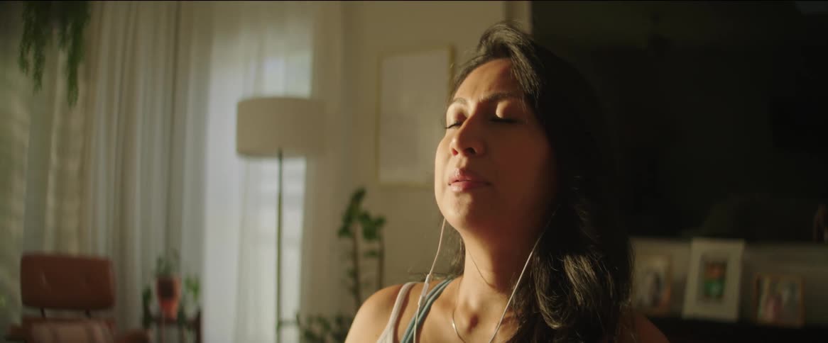 A woman is sitting down and relaxing