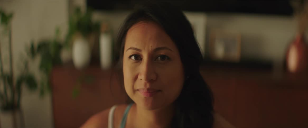 A woman turns her head and smiles