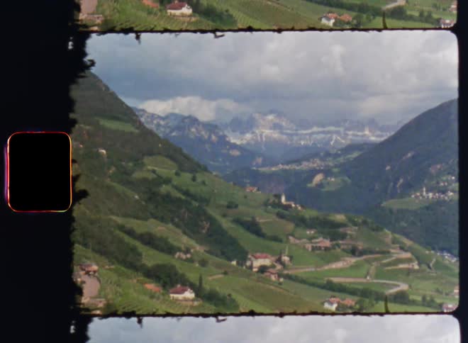 A rural village set in the valley between large mountains
