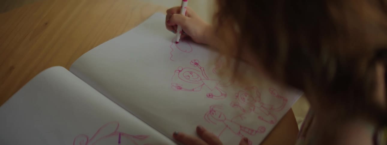A child is drawing with a marker