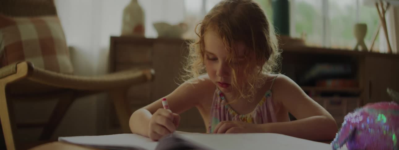Girl drawing in a drawing book