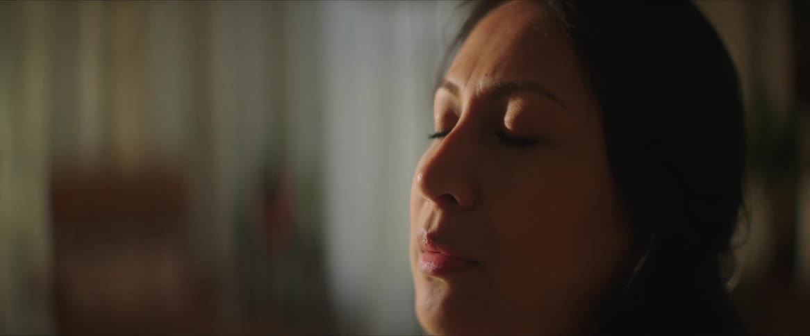 A woman closes her eyes to rest