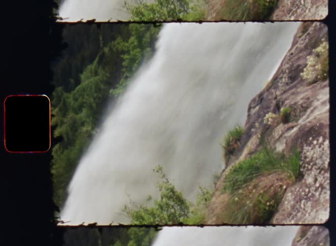 A waterfall down a cliff in the wilderness during the day
