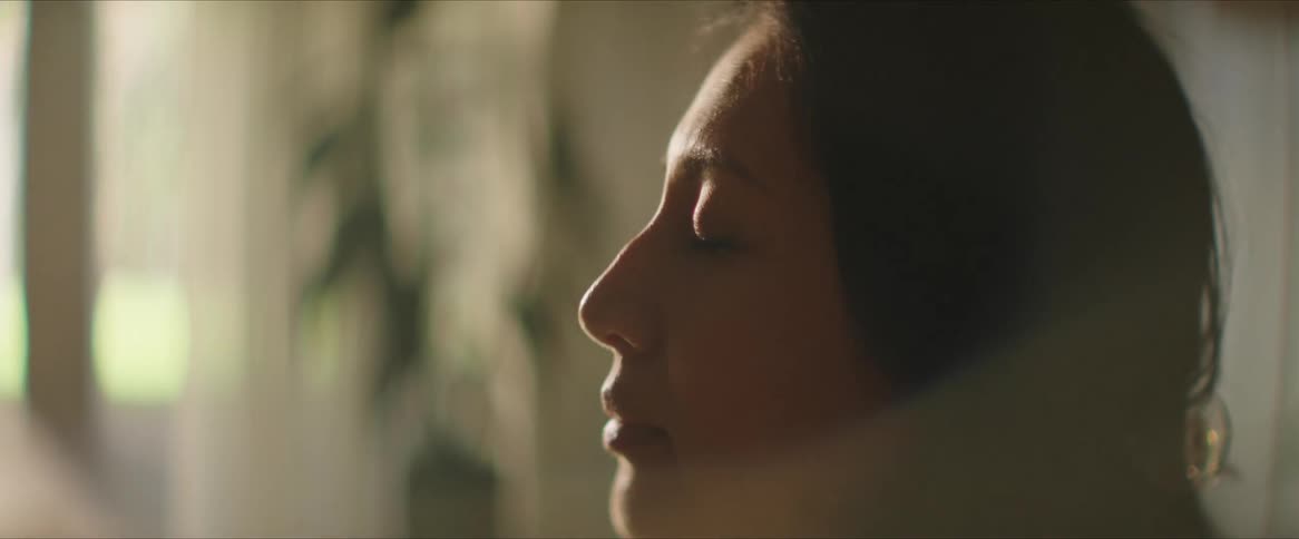 A woman is meditating with her eyes closed