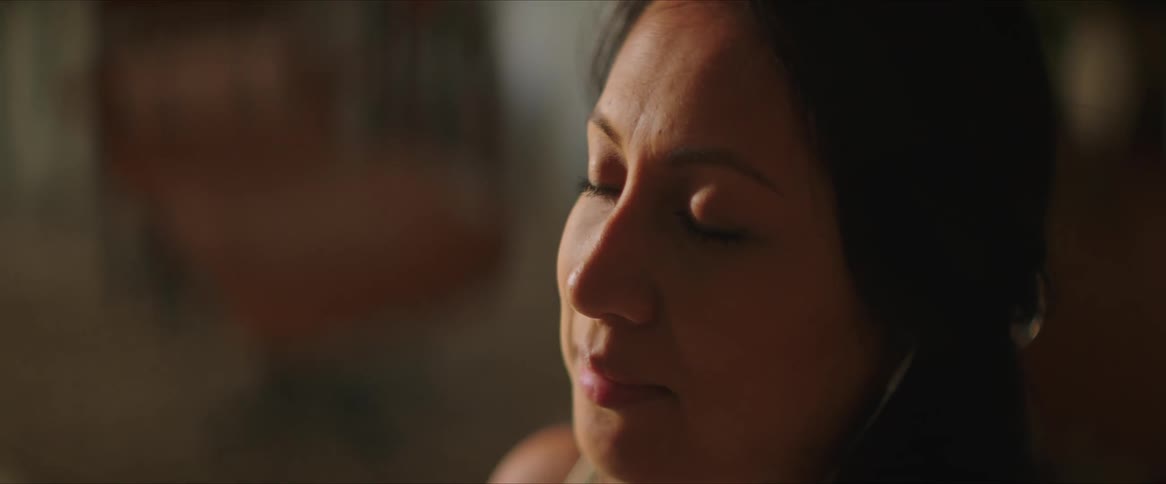 A portrait of a woman closing her eyes
