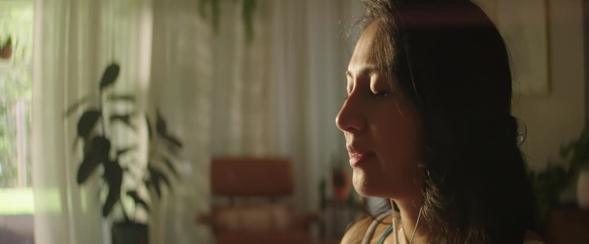 A woman is meditating at home