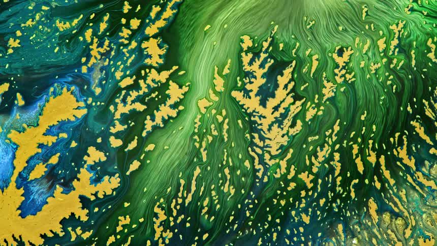 green and blue rivers of ink spread in a complex pattern on yellow paint