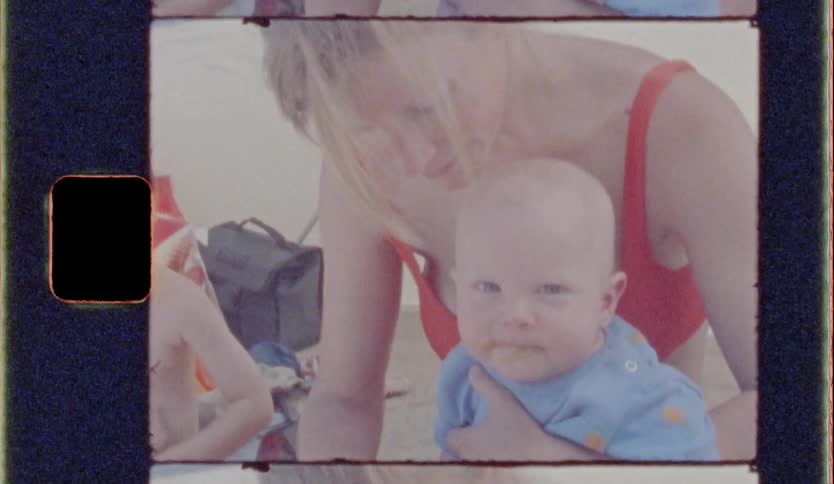 Mother wearing a bathing suit feeding her child