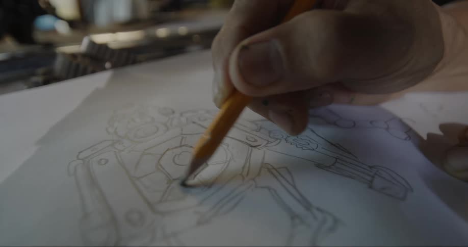 Person drawing a robot in a sketchbook