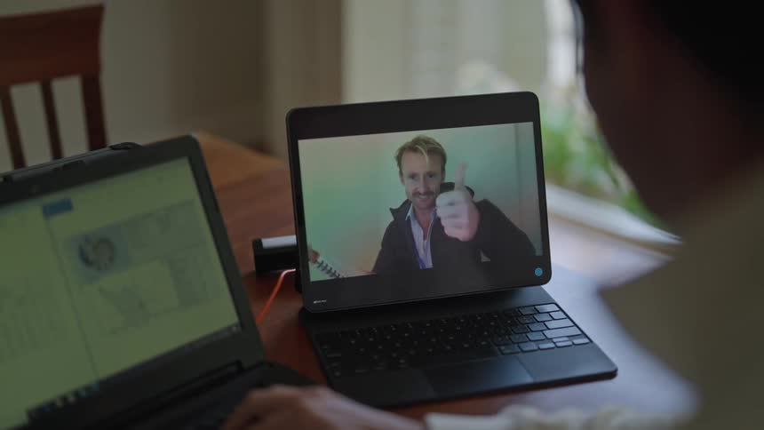 Two men are talking on a video call then say goodbye and end the call