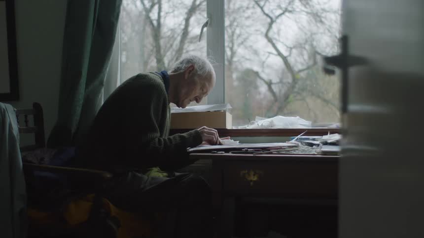 A man is painting at home