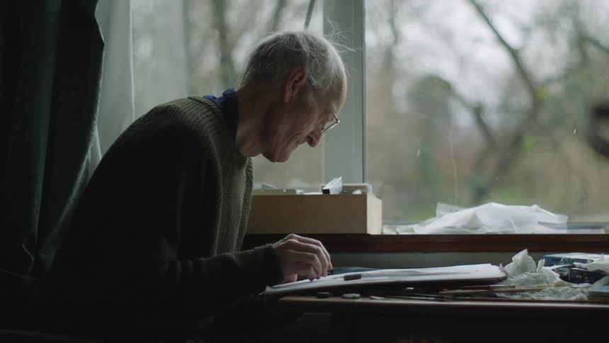 A man is painting at home
