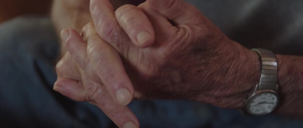 A man is clenching his hands