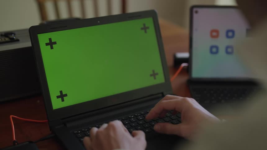 A man is typing on his laptop