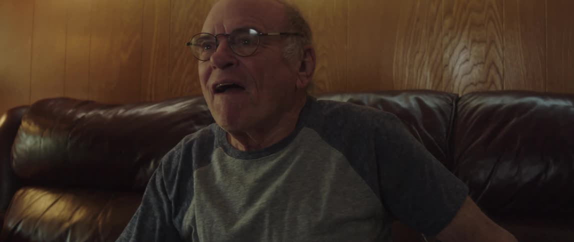 A man cheers at what he is watching