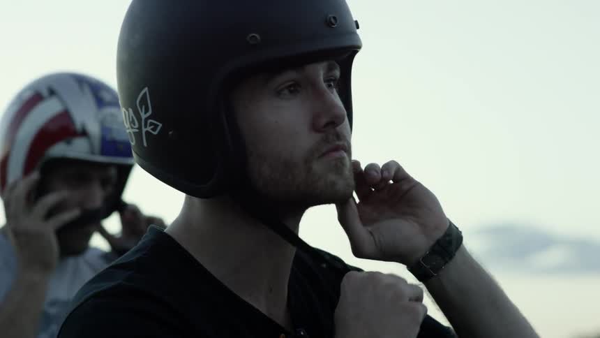 Motorcycle riders are putting on their helmets