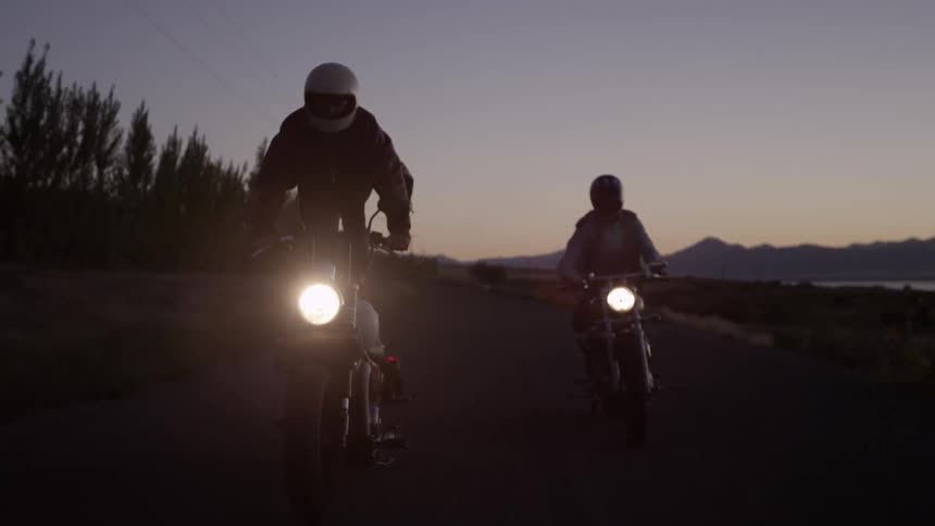 Two men motorcycle in a rural area