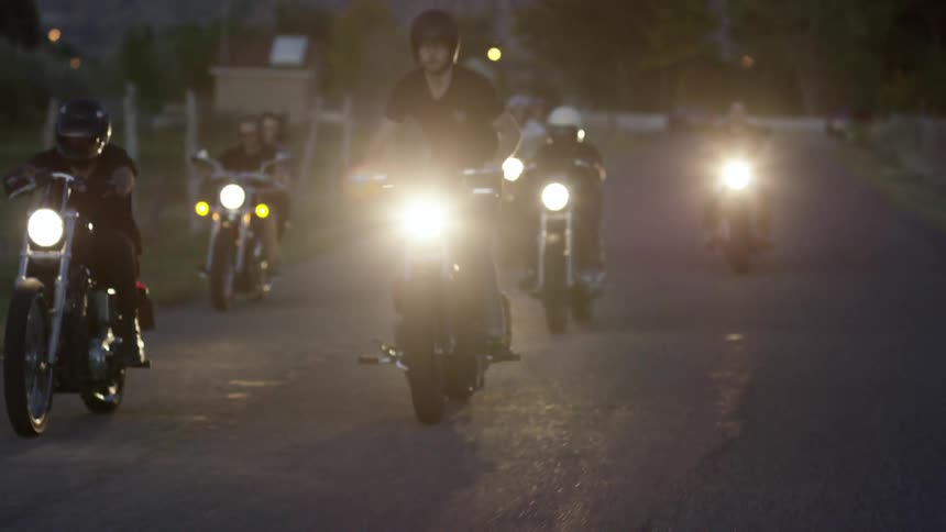 A group of people are riding motorcycles in a group