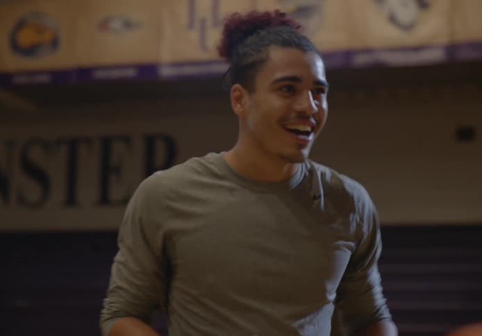 Two friends having fun playing basketball on a university basketball court