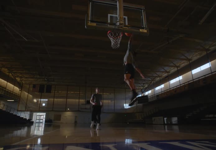 Three people are playing basketball