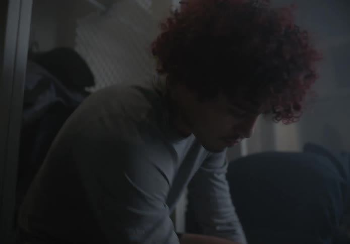 Two teenagers dress in the locker room