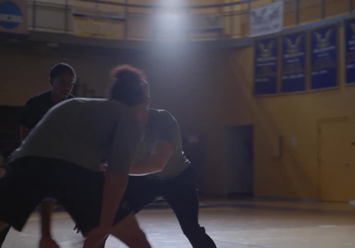 People are playing basketball on the court