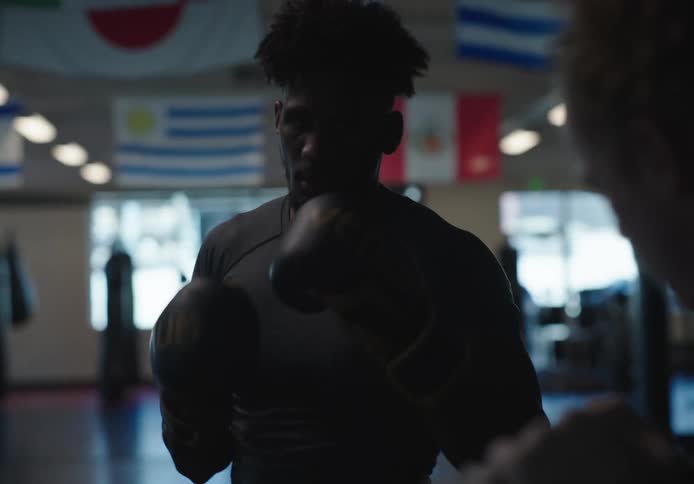 Black man training mixed martial arts at the gym