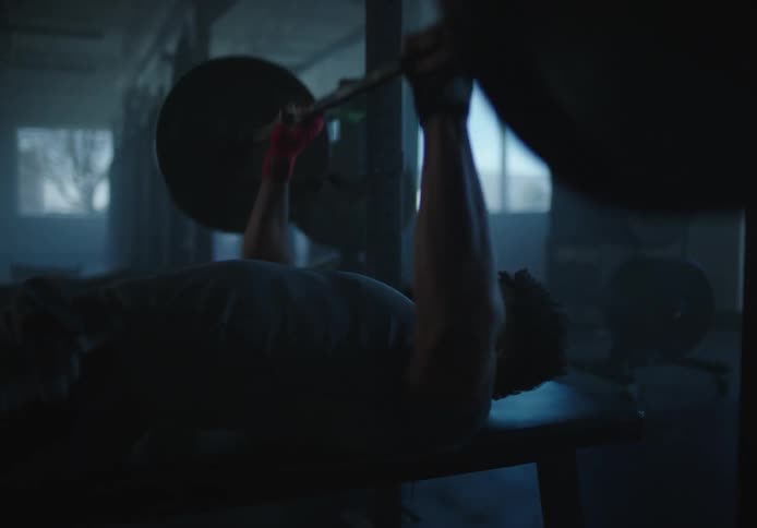 A man is lifting weights in the gym