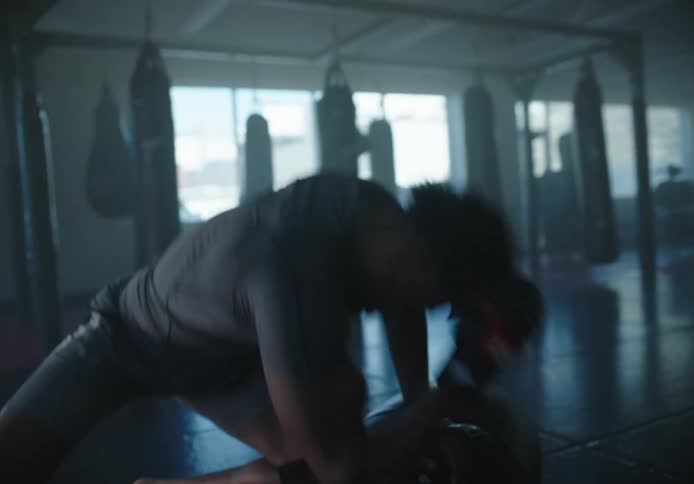 A man is pounding on a heavy bag