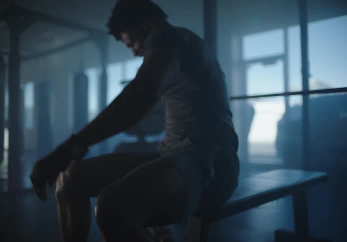 A man is bench pressing in the gym