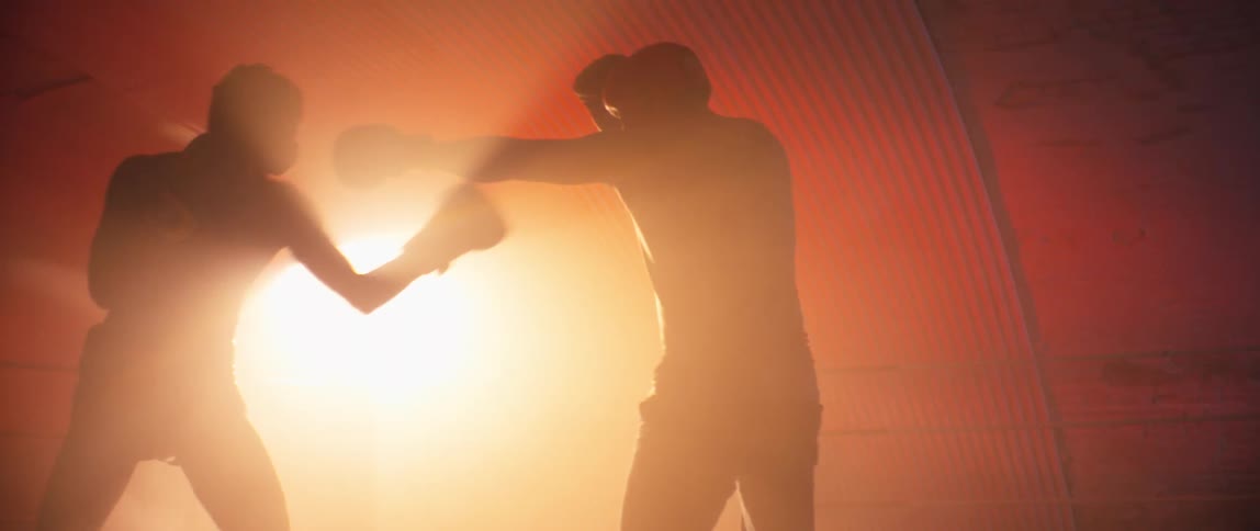 Two boxers are fighting in the ring