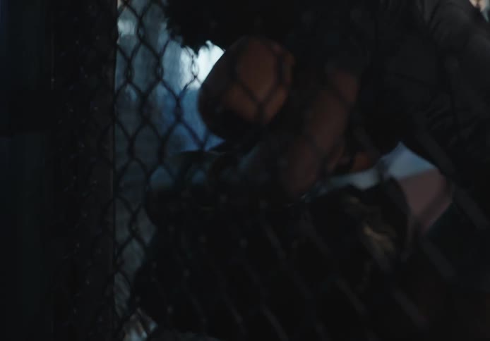 Two men are fighting in a cage