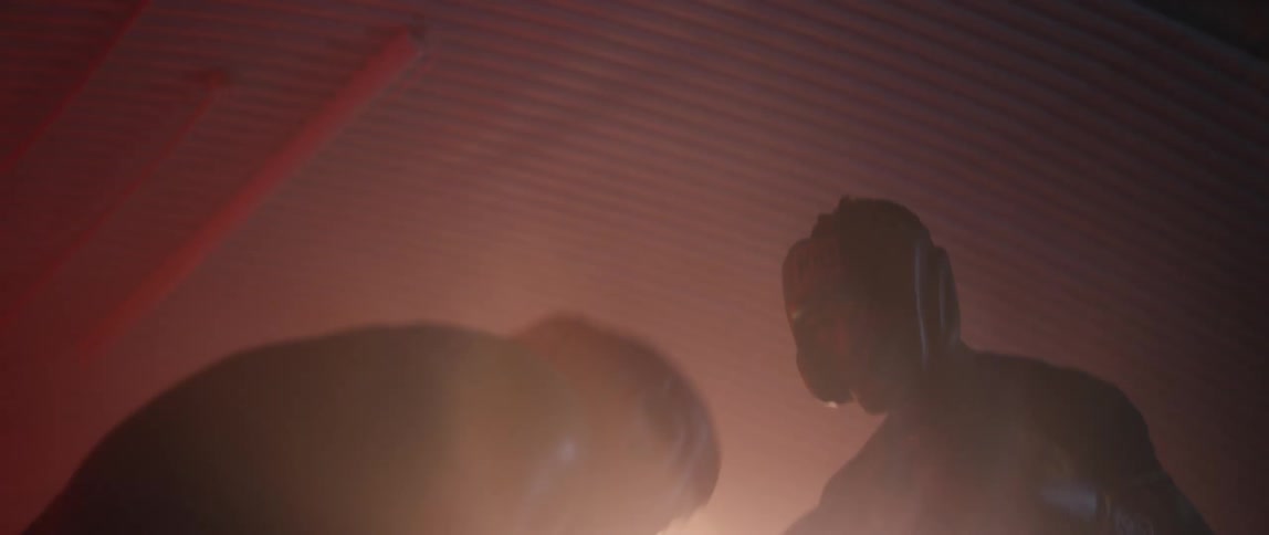Two men wearing boxing gear are boxing inside of a ring