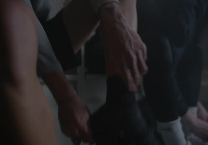 Two men dress in the locker room