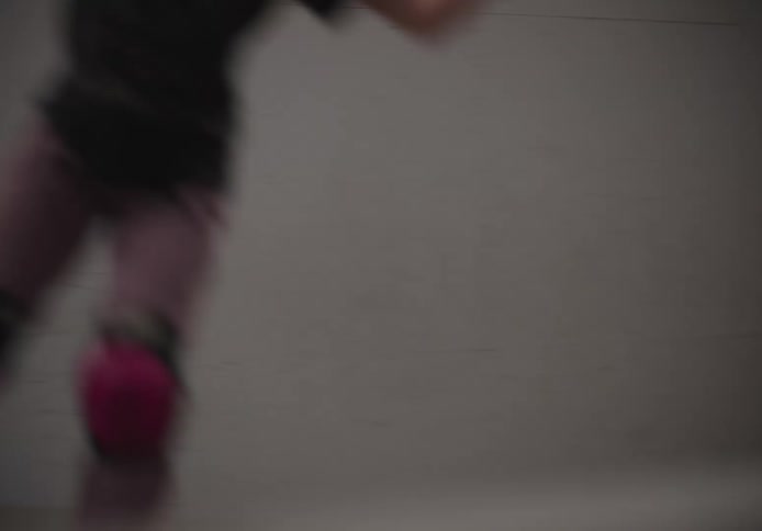 A girl is skateboarding on the ramps