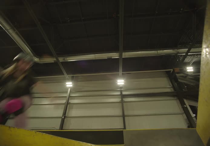 A girl jumps over a gap with her skateboard