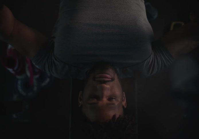 A man lifts weights on a weight bench