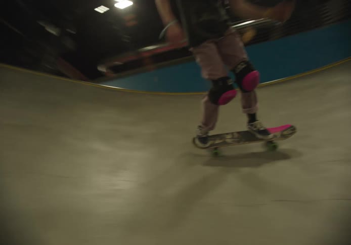A teenager is skateboarding on the ramp