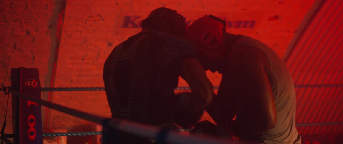 Two men sparring on a boxing ring